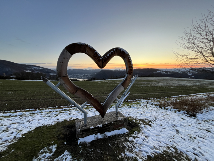 Holzherz vor Winterlandschaft
