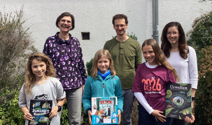 känguru2026 3 Schülerinnen, die Schulleiter und zwei Mathe-Kolleginnen freuen sich über die Buchpreise des Wettbewerbs.