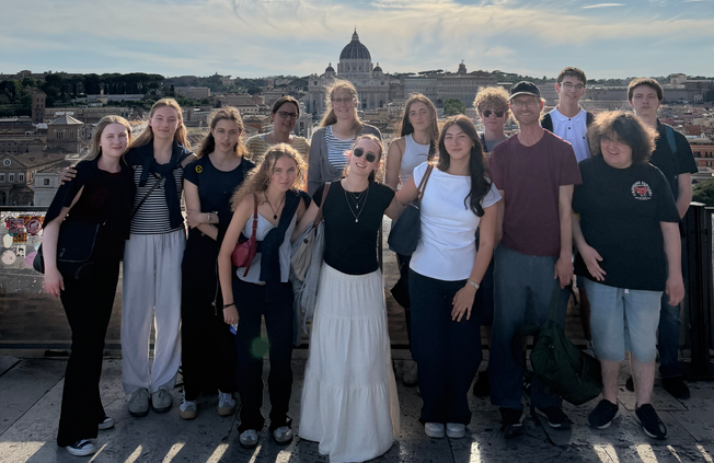 eine Schülergruppe steht vor der Stadt Rom